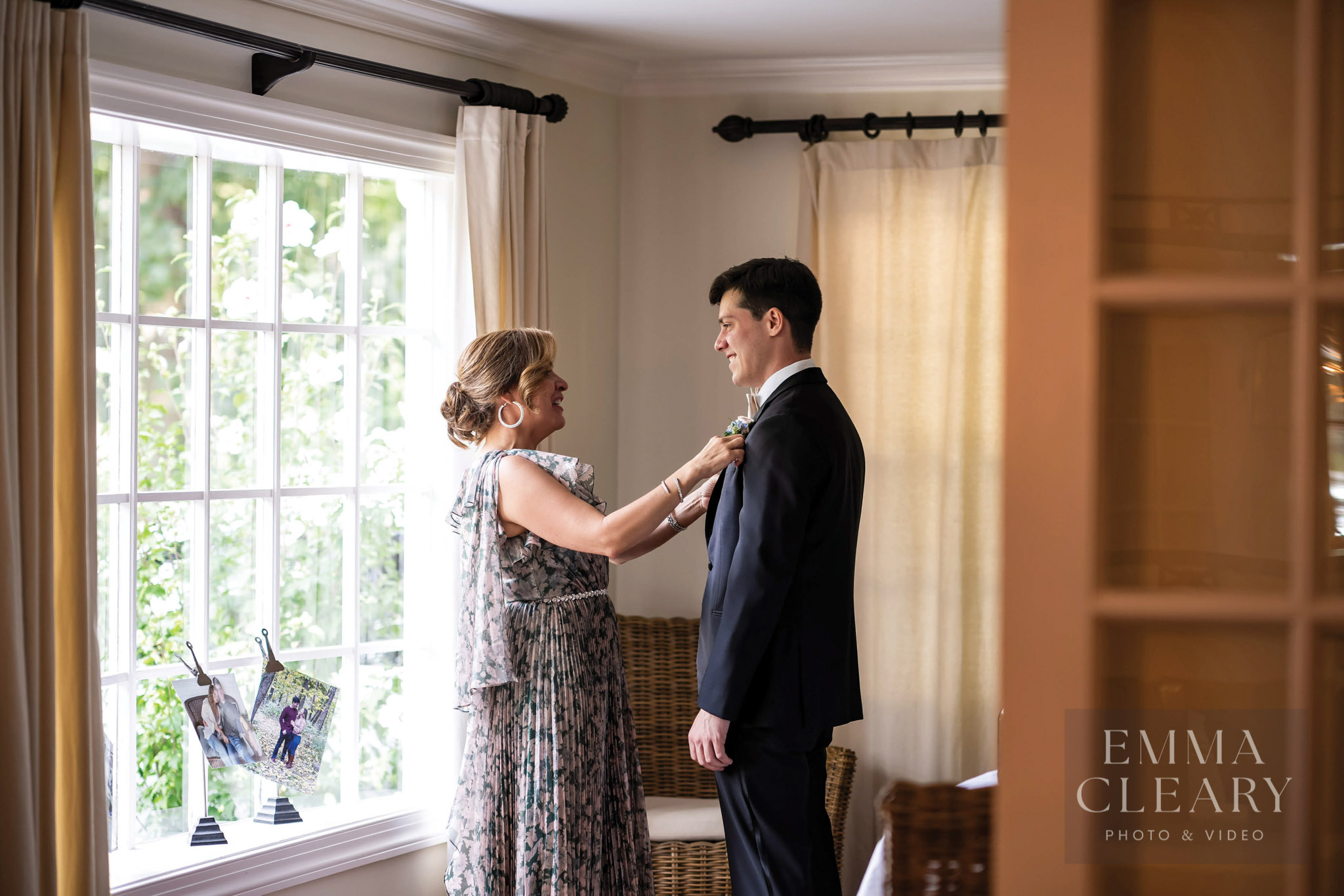 The mother of the groom fixes the bow tie
