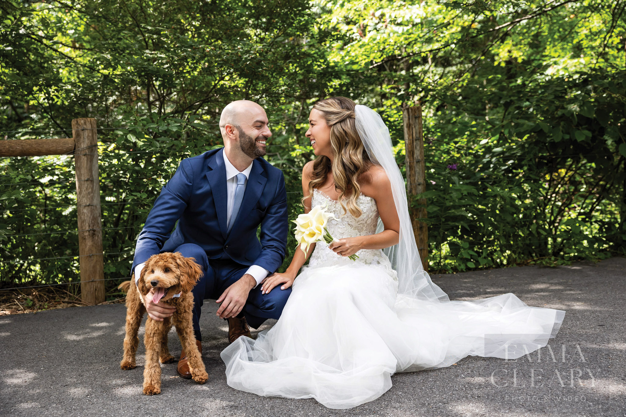 The bride and groom with their dog friend