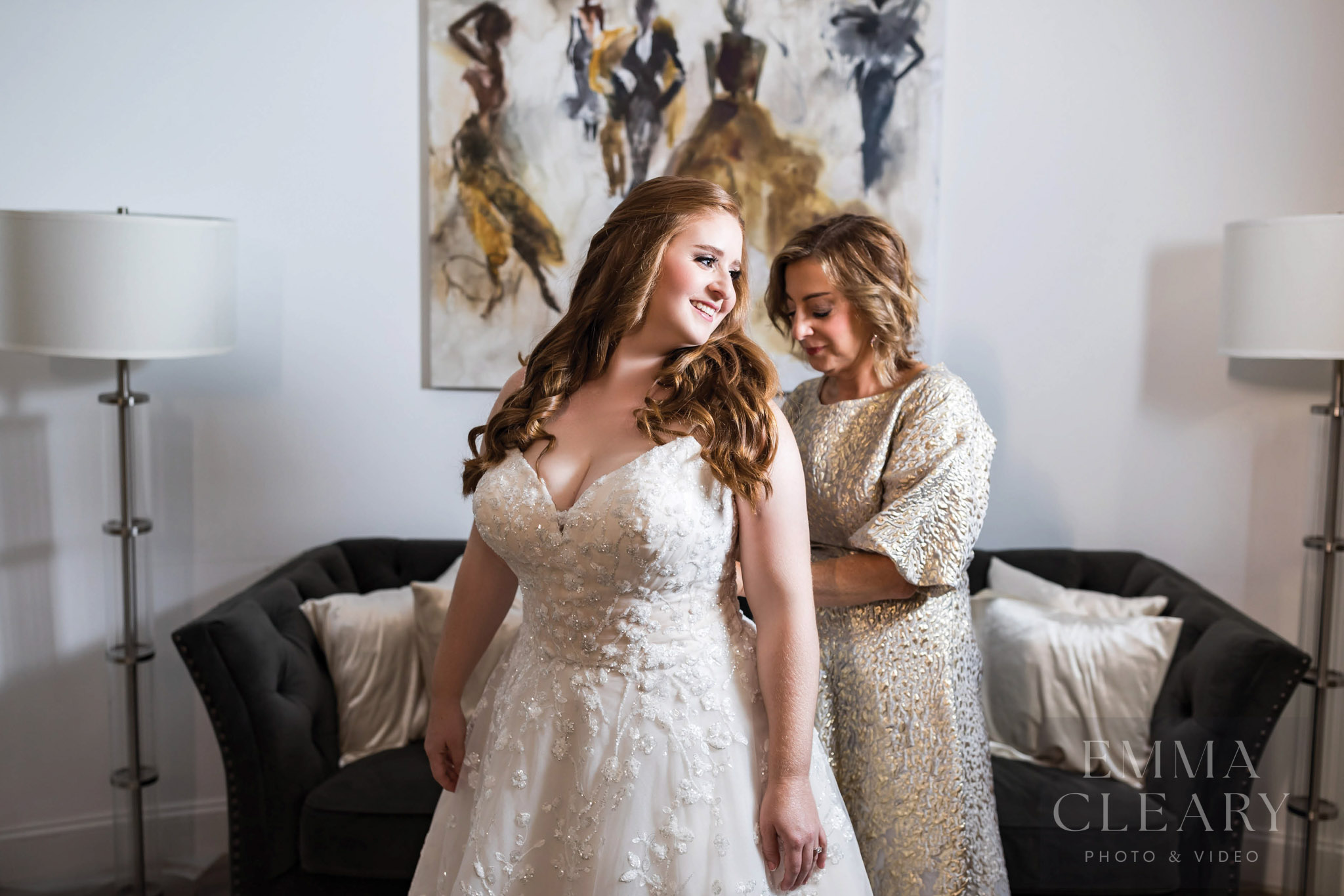 Mom helps the bride with the dress