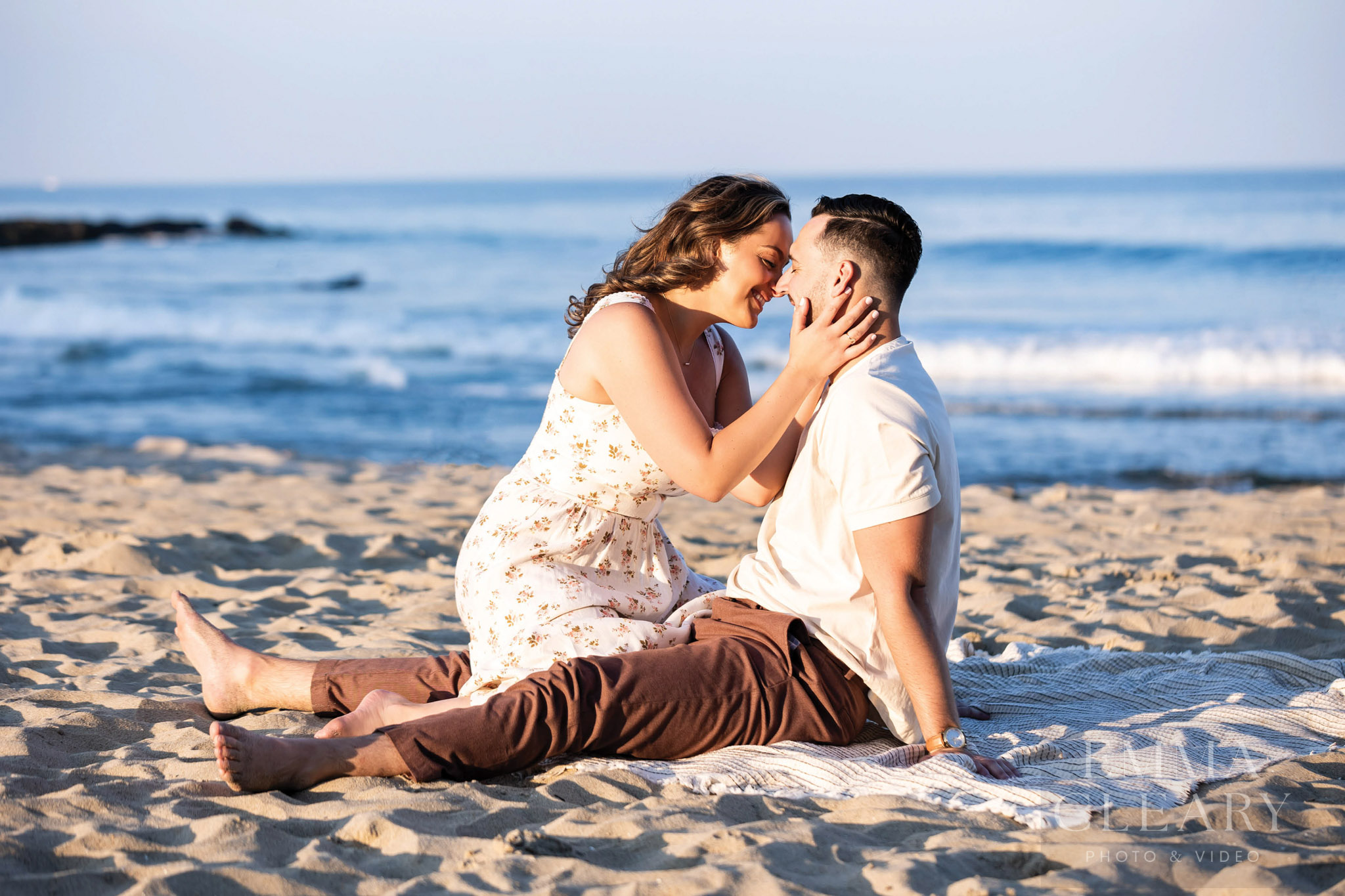 An engagement photo of a couple on the beach