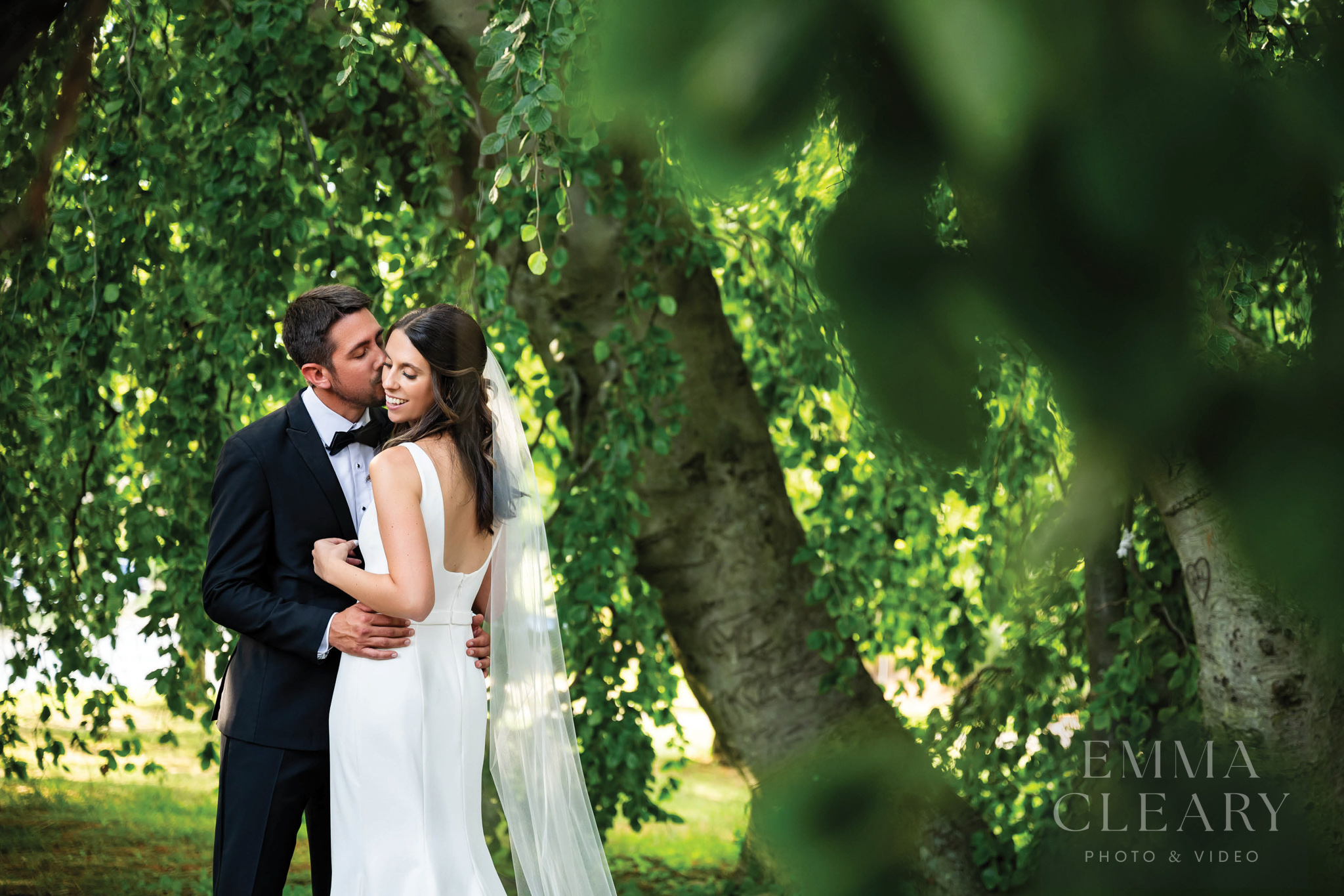 The groom kisses the bride