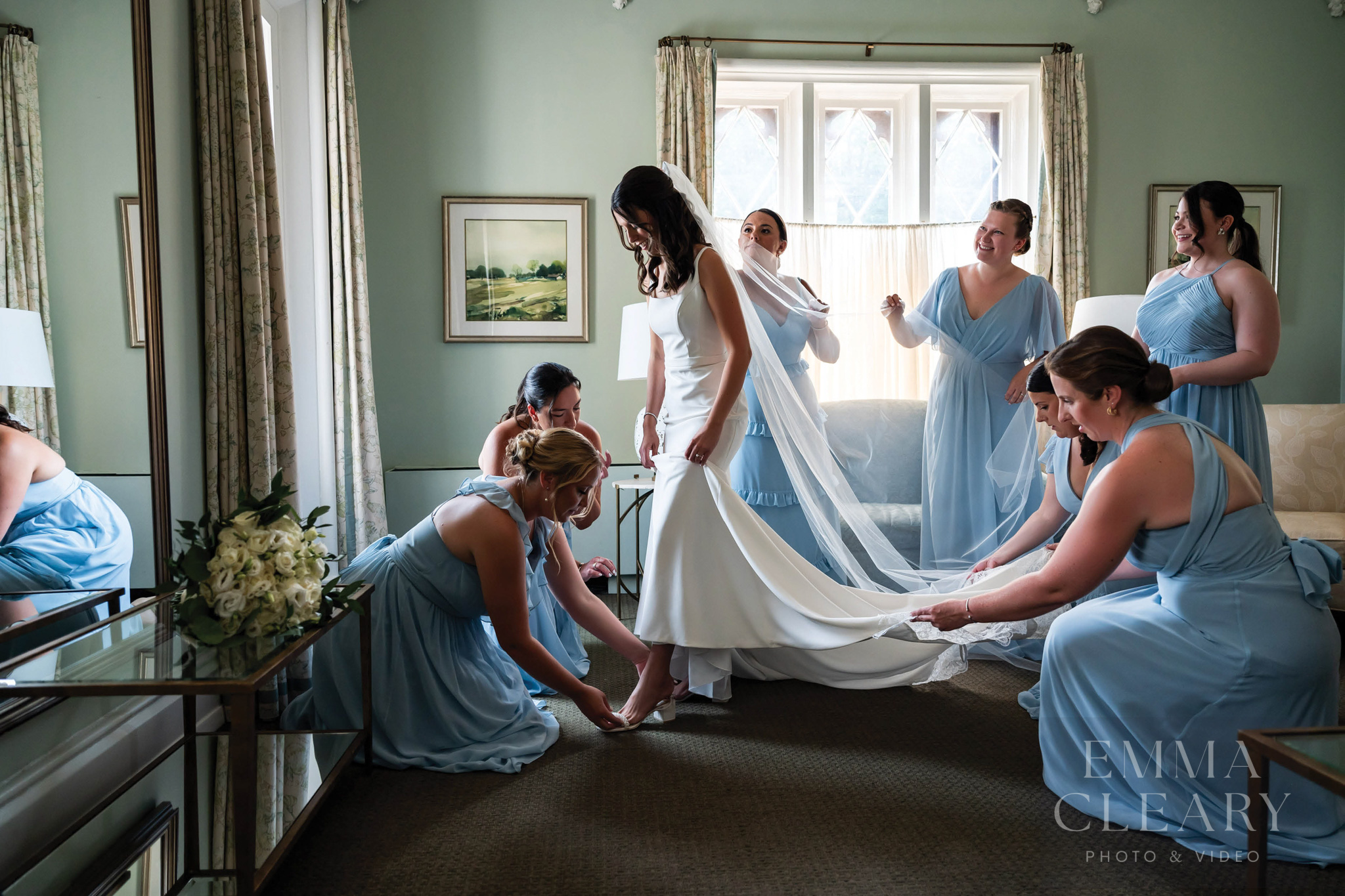 Bridesmaids help the bride