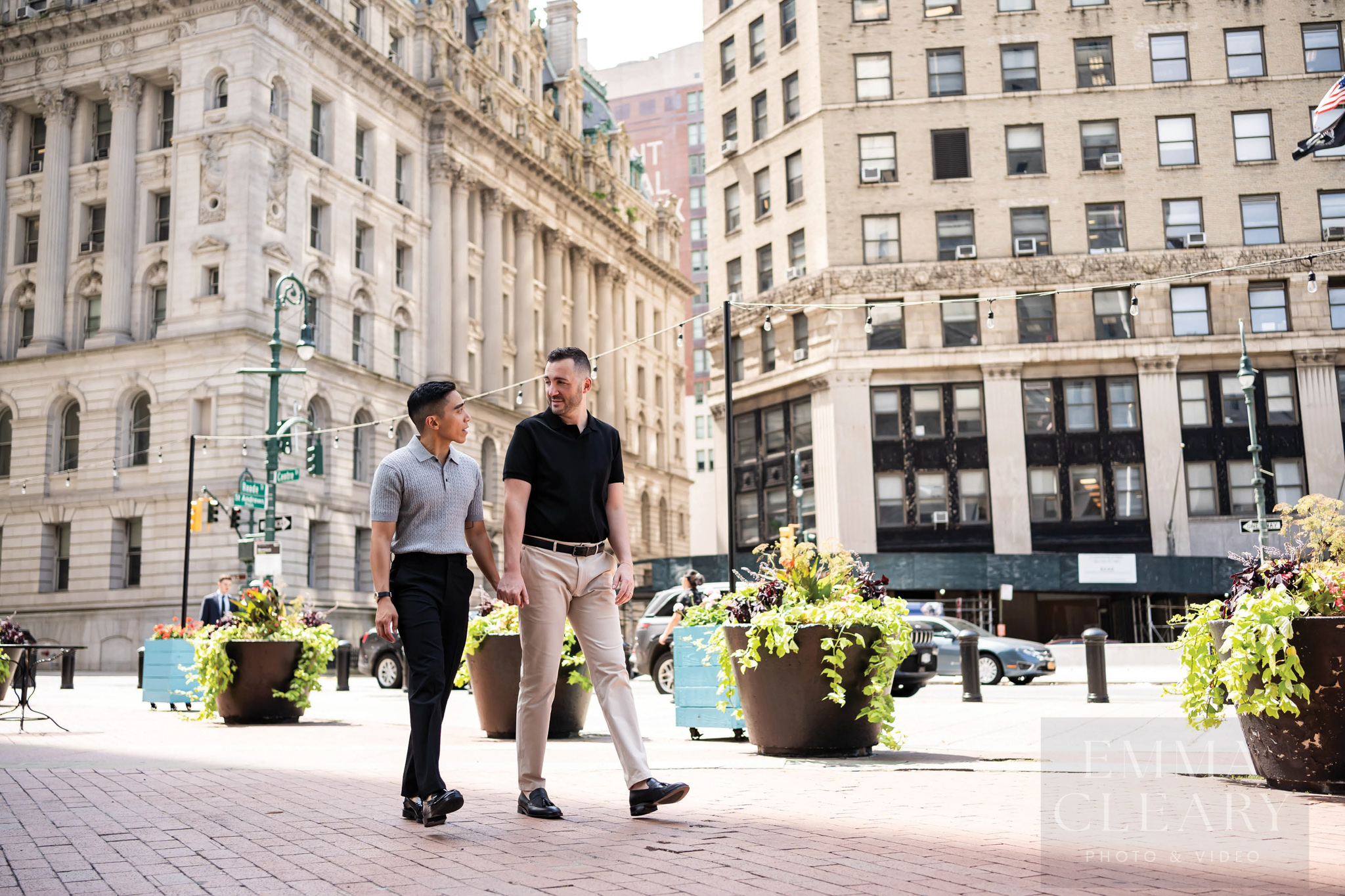 A wedding couple walks around the city