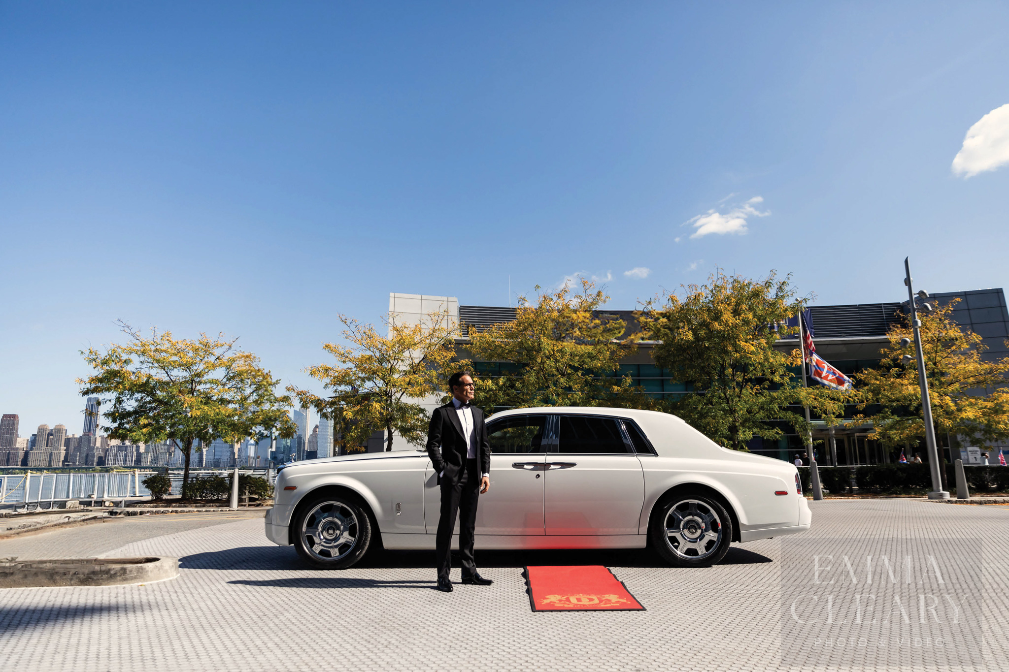 Photo of the groom at the wedding car