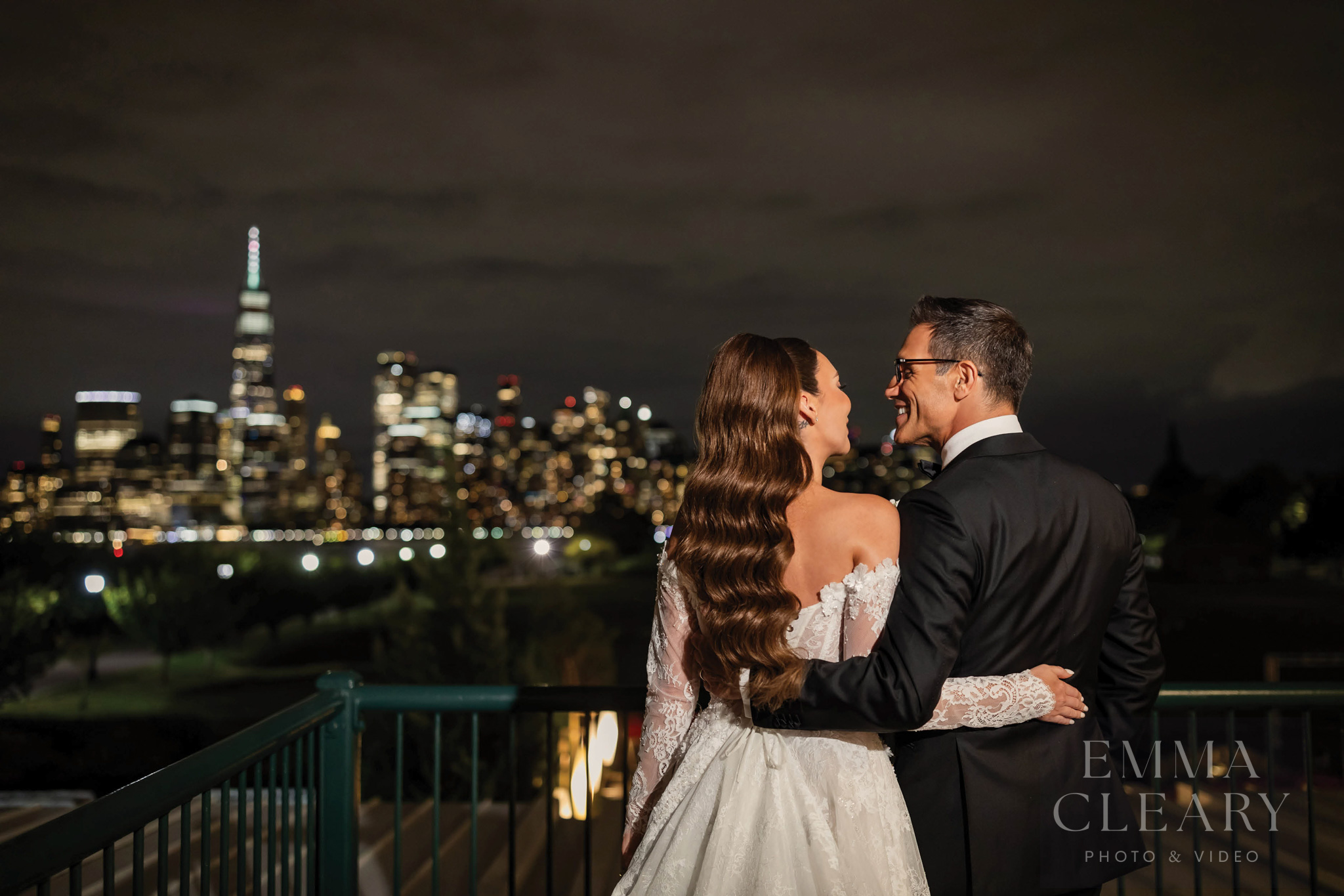 Photo of a couple with a view of the night city