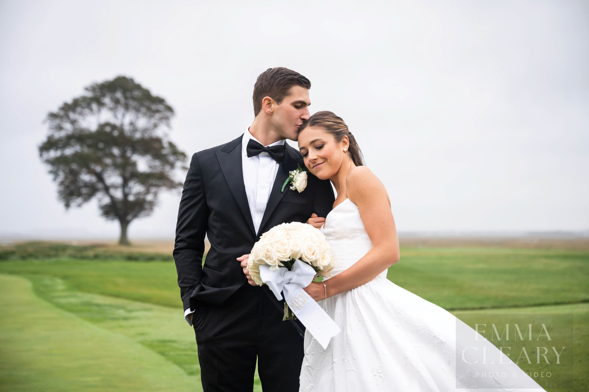 The groom kisses the bride