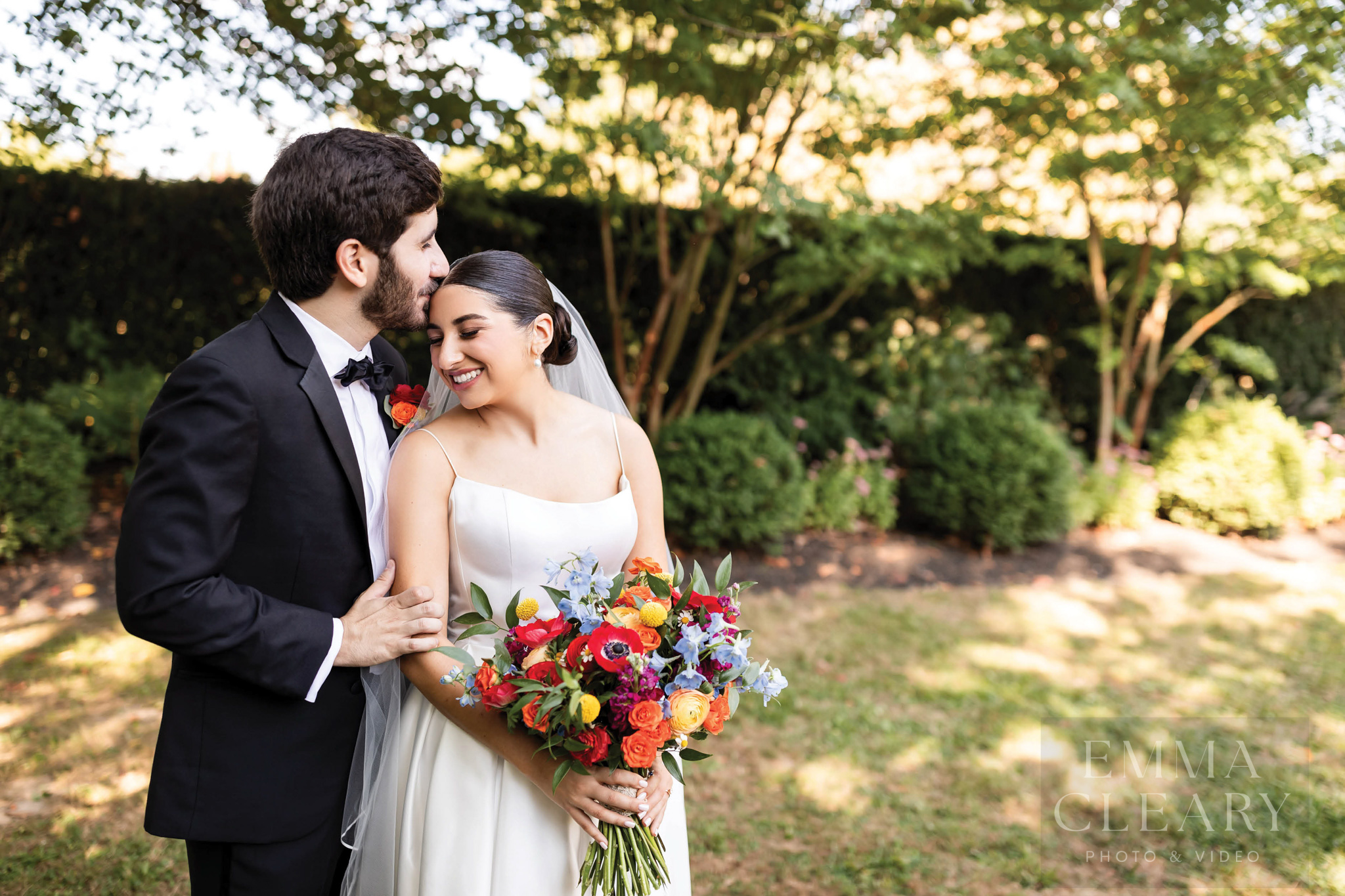 The groom kisses the bride