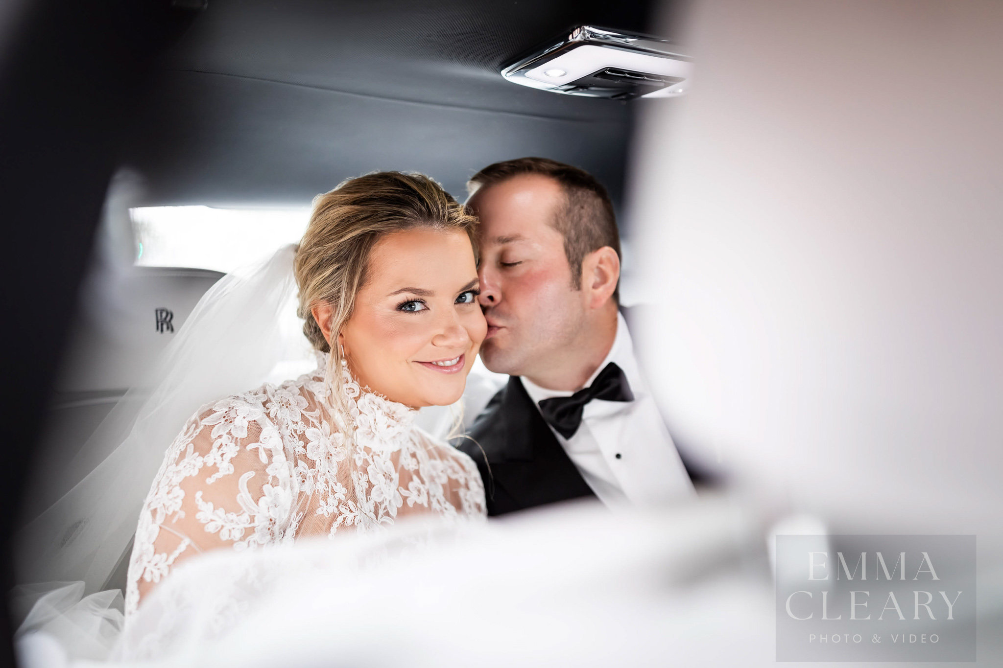 The groom kisses the bride