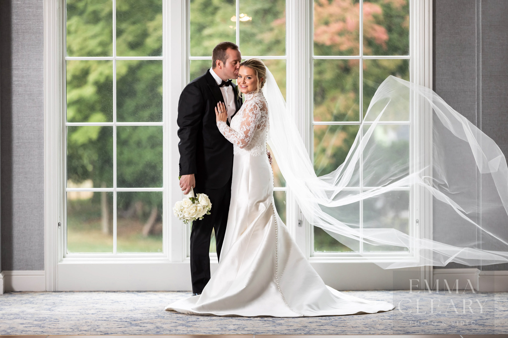 The groom kisses the bride