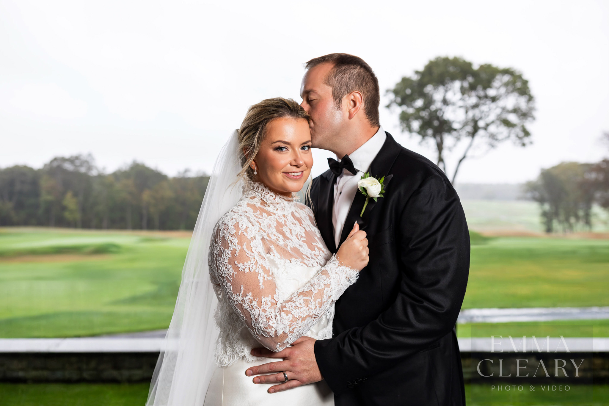 The groom kisses the bride