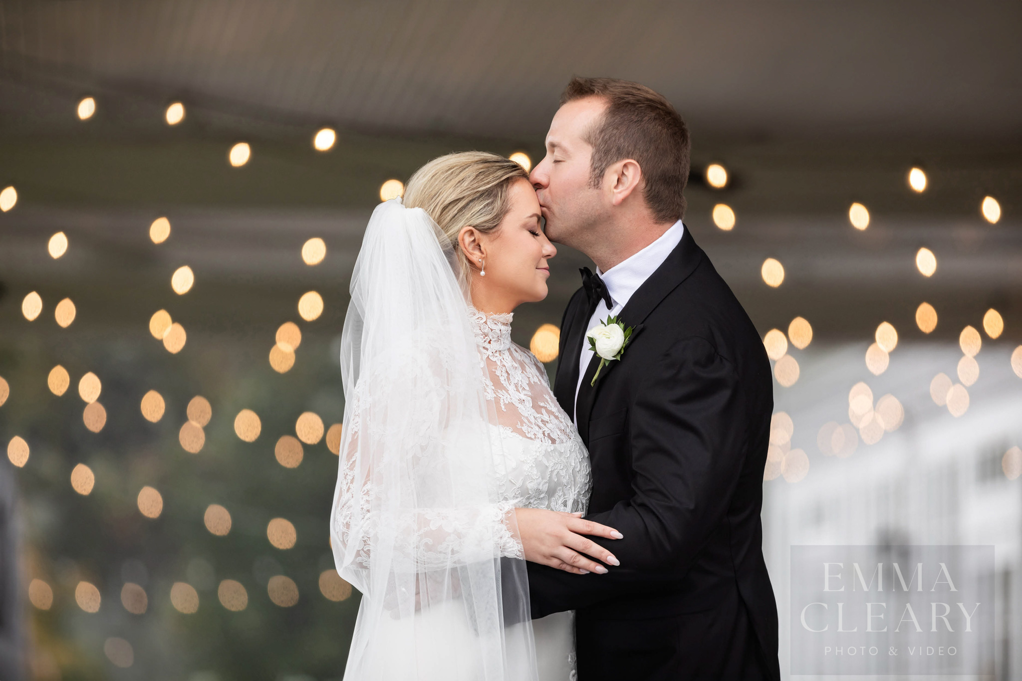 The groom kisses the bride