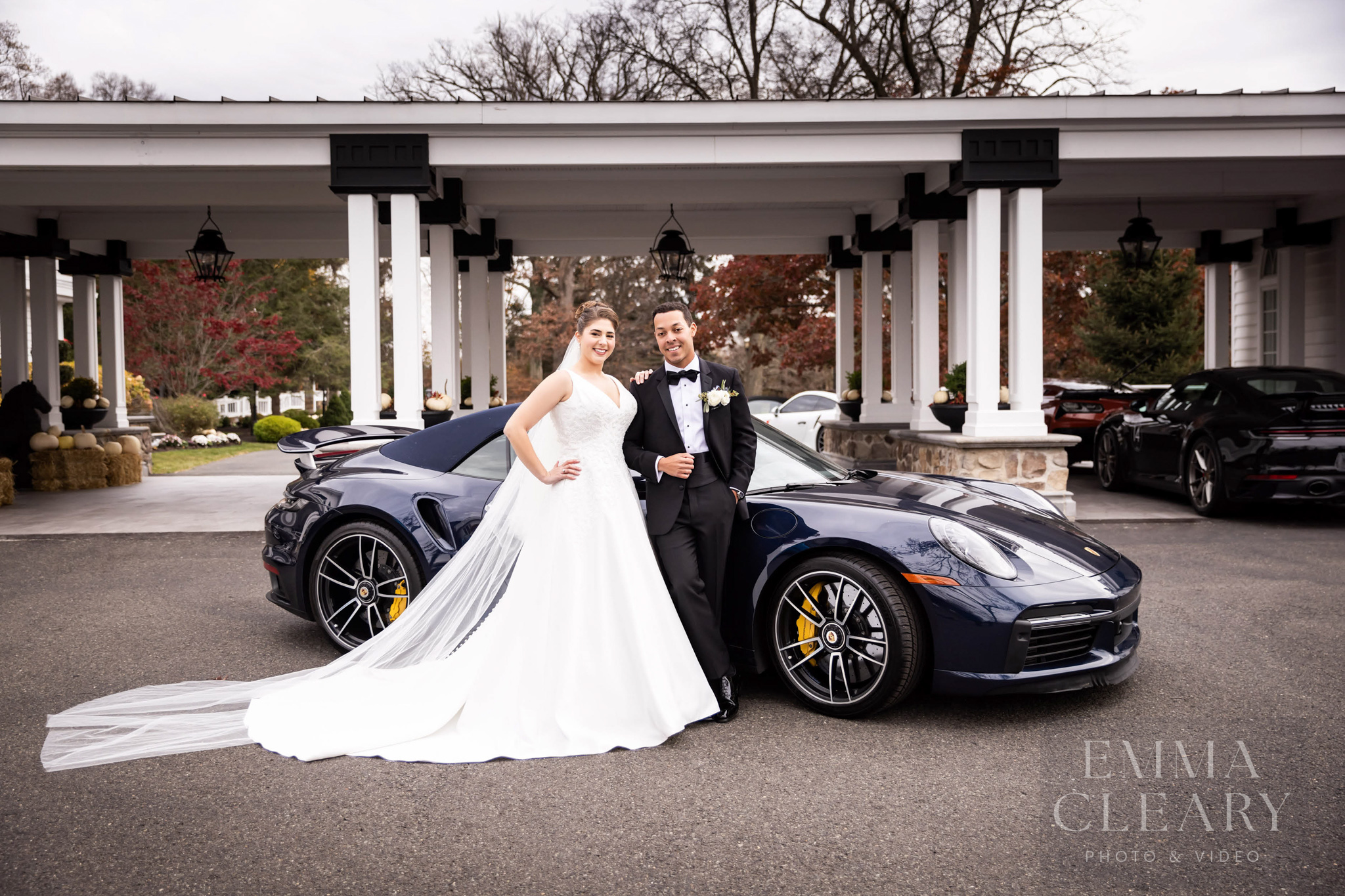 The wedding couple near the car
